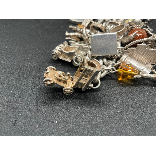 23 - HALLMARKED SILVER CHARM BRACELET WITH 23 SILVER & WHITE METAL CHARMS W113.8G - LOCKET IS CONTINENTAL... 