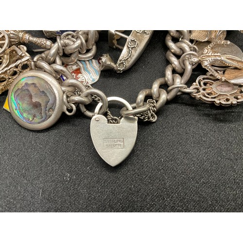 23 - HALLMARKED SILVER CHARM BRACELET WITH 23 SILVER & WHITE METAL CHARMS W113.8G - LOCKET IS CONTINENTAL... 