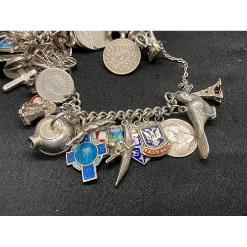24 - SILVER CHARM BRACELET (TESTED) WITH 43 SILVER & WHITE METAL CHARMS W100.6G ADDITIONAL CHARM IS NOT S... 