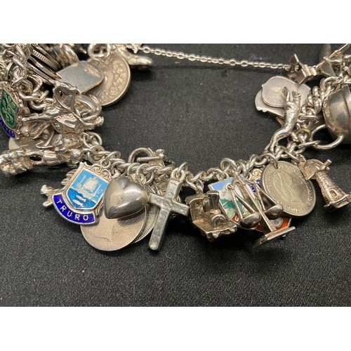 24 - SILVER CHARM BRACELET (TESTED) WITH 43 SILVER & WHITE METAL CHARMS W100.6G ADDITIONAL CHARM IS NOT S... 