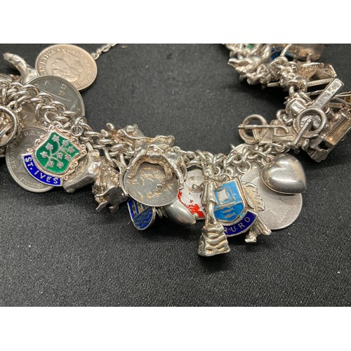 24 - SILVER CHARM BRACELET (TESTED) WITH 43 SILVER & WHITE METAL CHARMS W100.6G ADDITIONAL CHARM IS NOT S... 