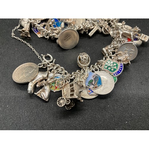 24 - SILVER CHARM BRACELET (TESTED) WITH 43 SILVER & WHITE METAL CHARMS W100.6G ADDITIONAL CHARM IS NOT S... 