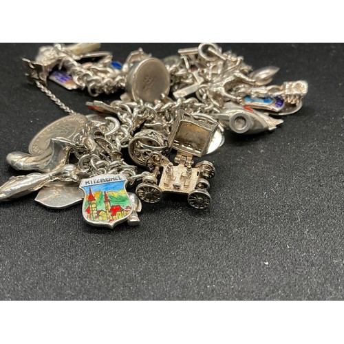 24 - SILVER CHARM BRACELET (TESTED) WITH 43 SILVER & WHITE METAL CHARMS W100.6G ADDITIONAL CHARM IS NOT S... 