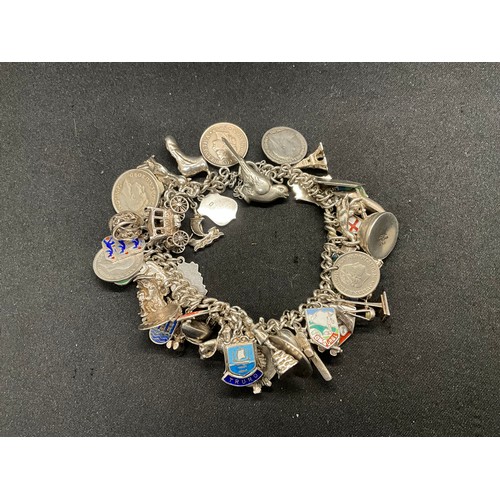 24 - SILVER CHARM BRACELET (TESTED) WITH 43 SILVER & WHITE METAL CHARMS W100.6G ADDITIONAL CHARM IS NOT S... 