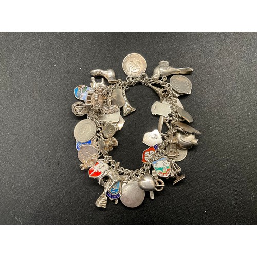 24 - SILVER CHARM BRACELET (TESTED) WITH 43 SILVER & WHITE METAL CHARMS W100.6G ADDITIONAL CHARM IS NOT S... 