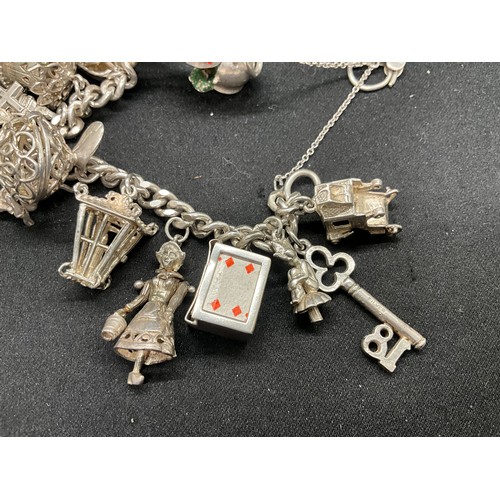 25 - SILVER CHARM BRACELET (TESTED) WITH 20 SILVER & WHITE METAL CHARMS W78.1G - LOCKET & CHAIN ENGLISH H... 