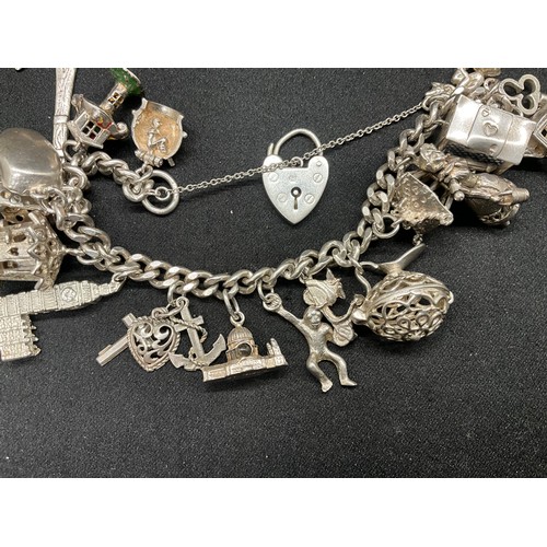 25 - SILVER CHARM BRACELET (TESTED) WITH 20 SILVER & WHITE METAL CHARMS W78.1G - LOCKET & CHAIN ENGLISH H... 