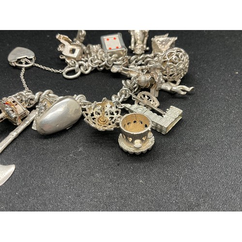 25 - SILVER CHARM BRACELET (TESTED) WITH 20 SILVER & WHITE METAL CHARMS W78.1G - LOCKET & CHAIN ENGLISH H... 