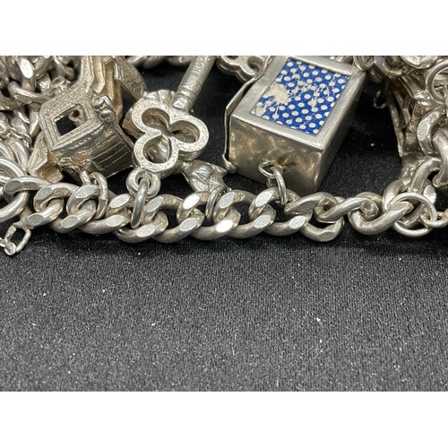 25 - SILVER CHARM BRACELET (TESTED) WITH 20 SILVER & WHITE METAL CHARMS W78.1G - LOCKET & CHAIN ENGLISH H... 