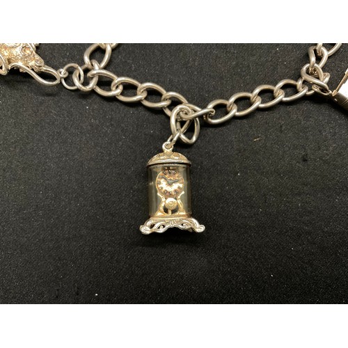 27 - 2 SILVER CHARM BRACELETS (TESTED) WITH A TOTAL OF 26 SILVER & WHITE METAL CHARMS - 2 ADDITIOINAL CHA... 