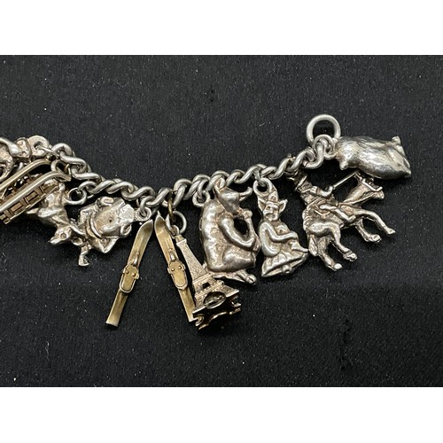 27 - 2 SILVER CHARM BRACELETS (TESTED) WITH A TOTAL OF 26 SILVER & WHITE METAL CHARMS - 2 ADDITIOINAL CHA... 