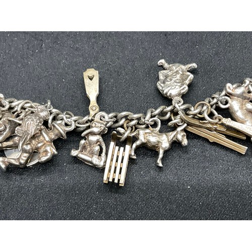 27 - 2 SILVER CHARM BRACELETS (TESTED) WITH A TOTAL OF 26 SILVER & WHITE METAL CHARMS - 2 ADDITIOINAL CHA... 
