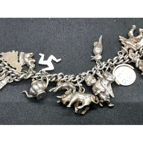 27 - 2 SILVER CHARM BRACELETS (TESTED) WITH A TOTAL OF 26 SILVER & WHITE METAL CHARMS - 2 ADDITIOINAL CHA... 