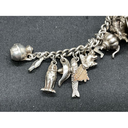 27 - 2 SILVER CHARM BRACELETS (TESTED) WITH A TOTAL OF 26 SILVER & WHITE METAL CHARMS - 2 ADDITIOINAL CHA... 