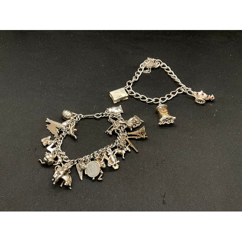 27 - 2 SILVER CHARM BRACELETS (TESTED) WITH A TOTAL OF 26 SILVER & WHITE METAL CHARMS - 2 ADDITIOINAL CHA... 