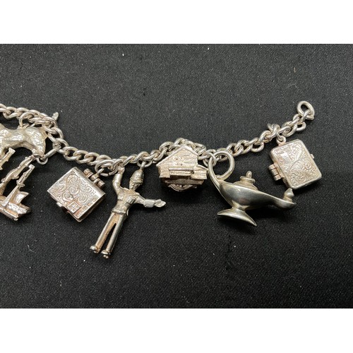 28 - 2 SILVER CHARM BRACELETS (TESTED) WITH A TOTAL OF 30 SILVER & WHITE METAL CHARMS TW104.2G
1 IS ENGLI... 