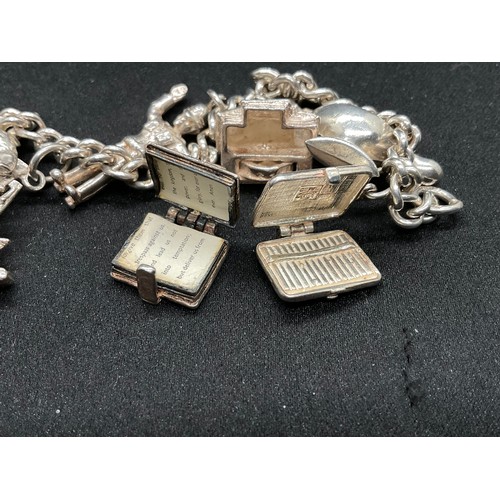 28 - 2 SILVER CHARM BRACELETS (TESTED) WITH A TOTAL OF 30 SILVER & WHITE METAL CHARMS TW104.2G
1 IS ENGLI... 