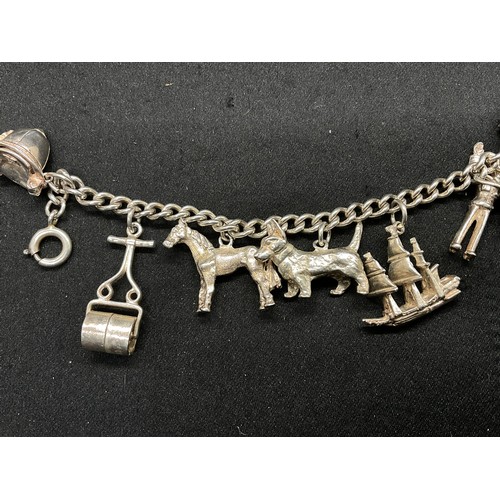 28 - 2 SILVER CHARM BRACELETS (TESTED) WITH A TOTAL OF 30 SILVER & WHITE METAL CHARMS TW104.2G
1 IS ENGLI... 