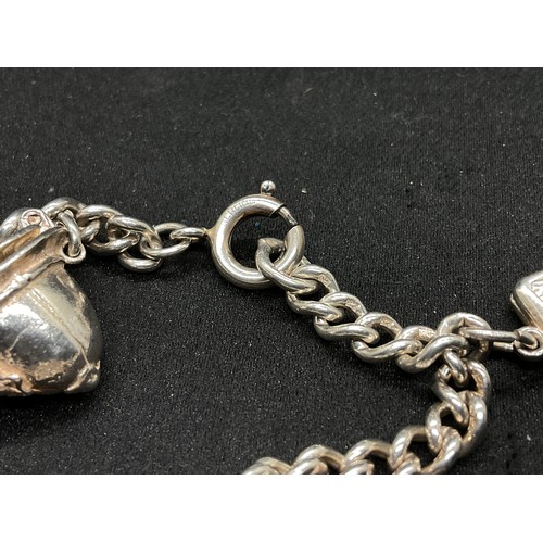 28 - 2 SILVER CHARM BRACELETS (TESTED) WITH A TOTAL OF 30 SILVER & WHITE METAL CHARMS TW104.2G
1 IS ENGLI... 