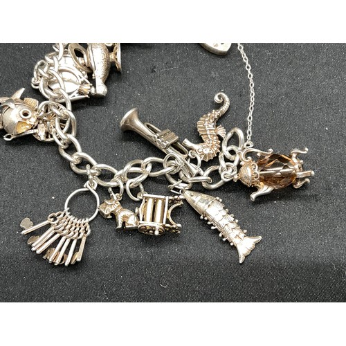 28 - 2 SILVER CHARM BRACELETS (TESTED) WITH A TOTAL OF 30 SILVER & WHITE METAL CHARMS TW104.2G
1 IS ENGLI... 