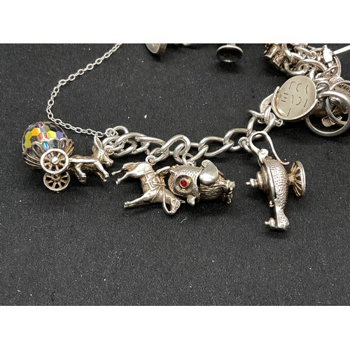 28 - 2 SILVER CHARM BRACELETS (TESTED) WITH A TOTAL OF 30 SILVER & WHITE METAL CHARMS TW104.2G
1 IS ENGLI... 