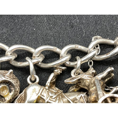 28 - 2 SILVER CHARM BRACELETS (TESTED) WITH A TOTAL OF 30 SILVER & WHITE METAL CHARMS TW104.2G
1 IS ENGLI... 