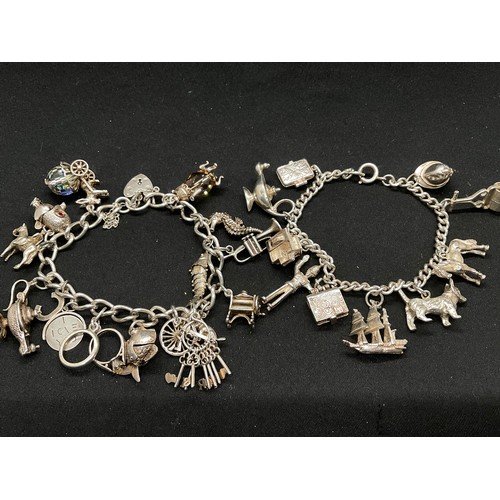 28 - 2 SILVER CHARM BRACELETS (TESTED) WITH A TOTAL OF 30 SILVER & WHITE METAL CHARMS TW104.2G
1 IS ENGLI... 