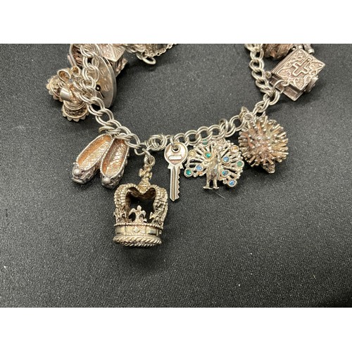30 - 2 SILVER CHARM BRACELETS (TESTED) WITH A TOTAL OF 33 SILVER & WHITE METAL CHARMS - 1 ADDITIONAL CHAR... 