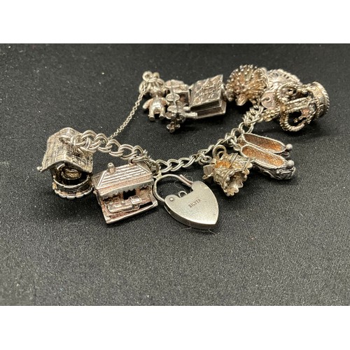 30 - 2 SILVER CHARM BRACELETS (TESTED) WITH A TOTAL OF 33 SILVER & WHITE METAL CHARMS - 1 ADDITIONAL CHAR... 