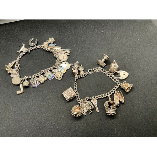 30 - 2 SILVER CHARM BRACELETS (TESTED) WITH A TOTAL OF 33 SILVER & WHITE METAL CHARMS - 1 ADDITIONAL CHAR... 