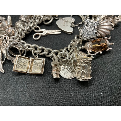31 - HALLMARKED SILVER CHARM BRACELET WITH 29 SILVER & WHITE METAL CHARMS W87.9G - LOCKET & CHAIN ENGLISH... 