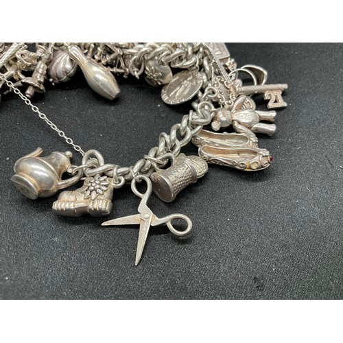 31 - HALLMARKED SILVER CHARM BRACELET WITH 29 SILVER & WHITE METAL CHARMS W87.9G - LOCKET & CHAIN ENGLISH... 