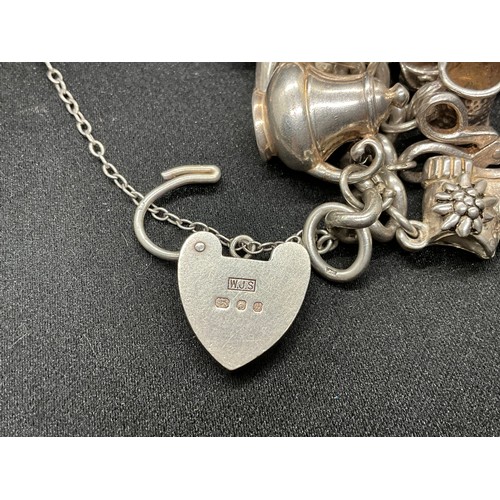 31 - HALLMARKED SILVER CHARM BRACELET WITH 29 SILVER & WHITE METAL CHARMS W87.9G - LOCKET & CHAIN ENGLISH... 