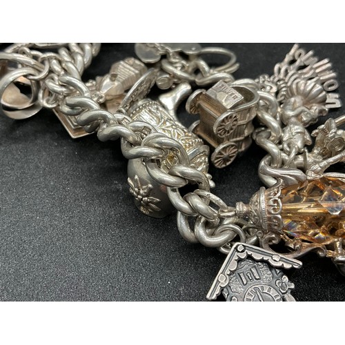 31 - HALLMARKED SILVER CHARM BRACELET WITH 29 SILVER & WHITE METAL CHARMS W87.9G - LOCKET & CHAIN ENGLISH... 