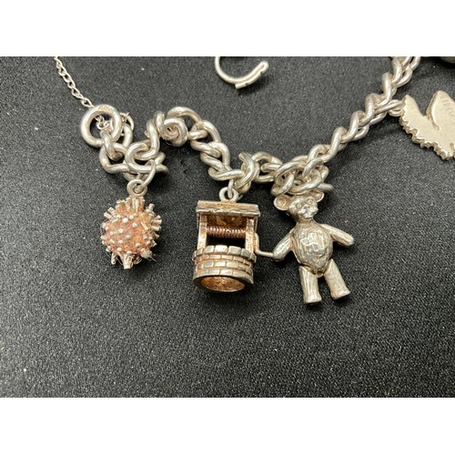 32 - 2 SILVER CHARM BRACELETS (TESTED) WITH A TOTAL OF 23 SILVER & WHITE METAL CHARMS TW71.3G
CLASP ON ON... 