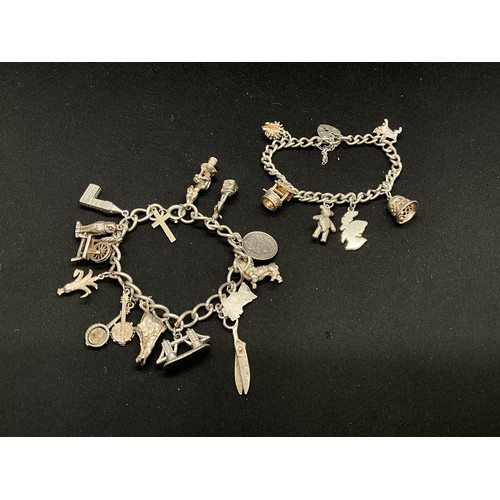 32 - 2 SILVER CHARM BRACELETS (TESTED) WITH A TOTAL OF 23 SILVER & WHITE METAL CHARMS TW71.3G
CLASP ON ON... 