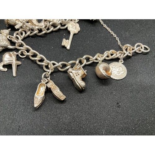 35 - 1 SILVER CHARM BRACELET (TESTED)  AND 1 BRACELET PLATED - WITH A TOTAL OF 19 SILVER CHARMS  WITH 1 A... 