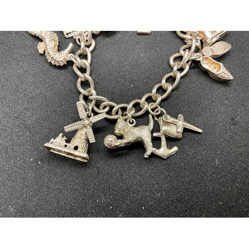 35 - 1 SILVER CHARM BRACELET (TESTED)  AND 1 BRACELET PLATED - WITH A TOTAL OF 19 SILVER CHARMS  WITH 1 A... 