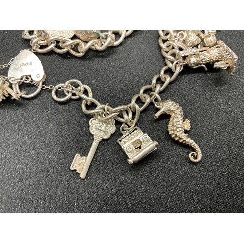 35 - 1 SILVER CHARM BRACELET (TESTED)  AND 1 BRACELET PLATED - WITH A TOTAL OF 19 SILVER CHARMS  WITH 1 A... 