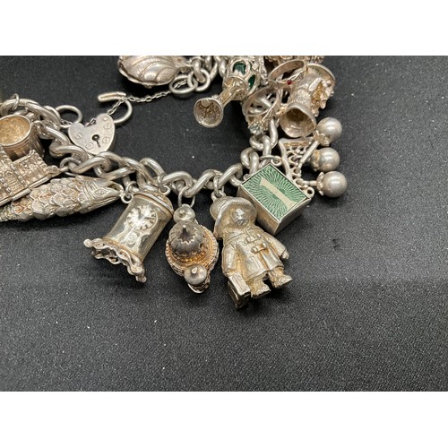 39 - HALLMARKED SILVER CHARM BRACELET WITH 19 SILVER & WHITE METAL CHARMS TW123.2G - ENGLISH HALLMARK SIL... 