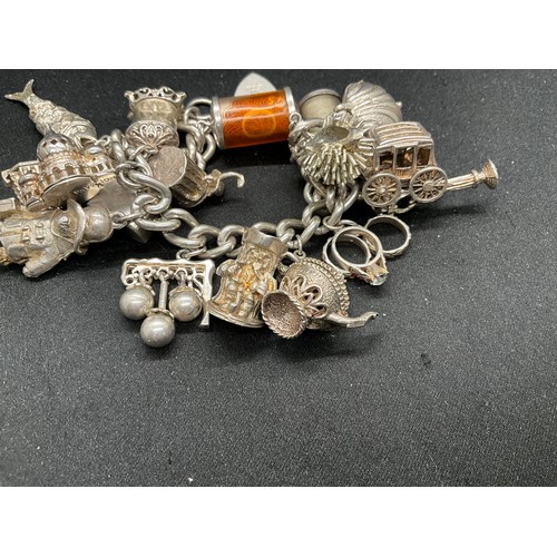 39 - HALLMARKED SILVER CHARM BRACELET WITH 19 SILVER & WHITE METAL CHARMS TW123.2G - ENGLISH HALLMARK SIL... 