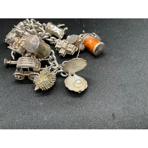 39 - HALLMARKED SILVER CHARM BRACELET WITH 19 SILVER & WHITE METAL CHARMS TW123.2G - ENGLISH HALLMARK SIL... 