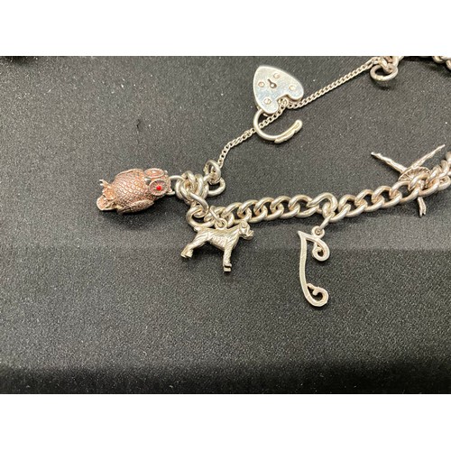 40 - 2 SILVER CHARM BRACELETS (TESTED)WITH A TOTAL OF 26 SILVER & WHITE METAL CHARMS W67.7G
BOTH LOCKETS ... 