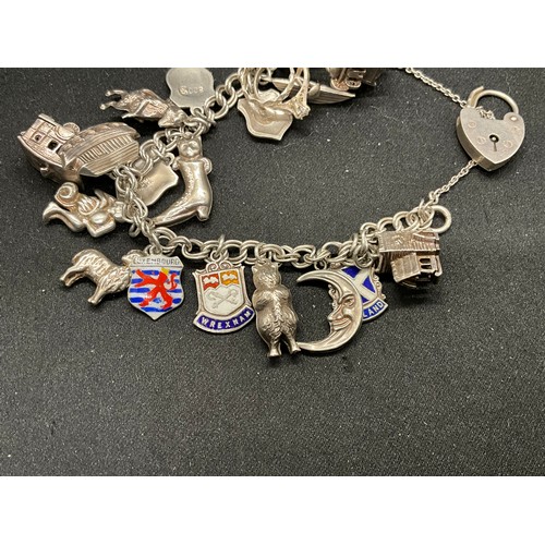 40 - 2 SILVER CHARM BRACELETS (TESTED)WITH A TOTAL OF 26 SILVER & WHITE METAL CHARMS W67.7G
BOTH LOCKETS ... 