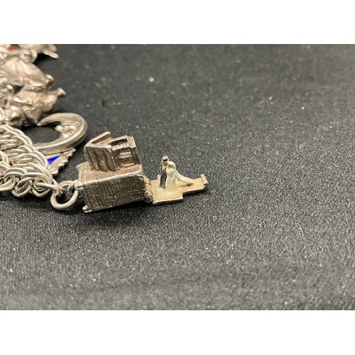 40 - 2 SILVER CHARM BRACELETS (TESTED)WITH A TOTAL OF 26 SILVER & WHITE METAL CHARMS W67.7G
BOTH LOCKETS ... 
