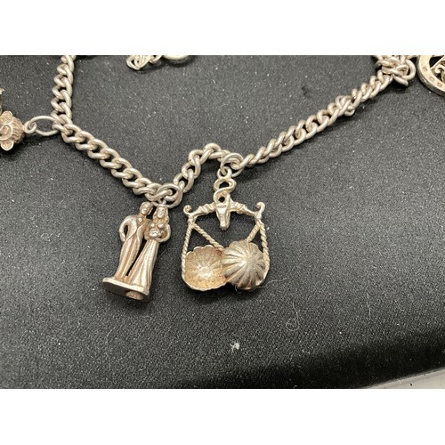 41 - 2 SILVER CHARM BRACELETS (TESTED) WITH TOTAL OF 32 SILVER & WHITE METAL CHARMS  TW94.1G
1 LOCKET IS ... 