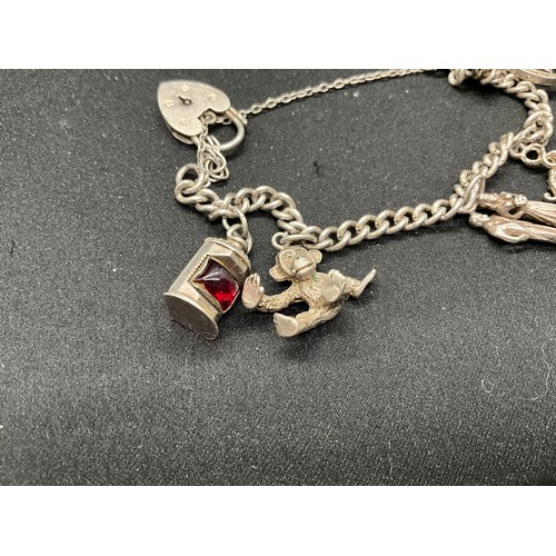 41 - 2 SILVER CHARM BRACELETS (TESTED) WITH TOTAL OF 32 SILVER & WHITE METAL CHARMS  TW94.1G
1 LOCKET IS ... 