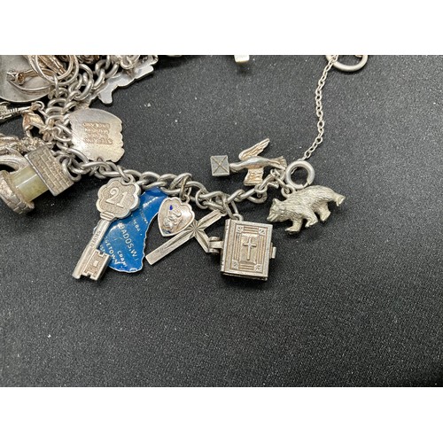 41 - 2 SILVER CHARM BRACELETS (TESTED) WITH TOTAL OF 32 SILVER & WHITE METAL CHARMS  TW94.1G
1 LOCKET IS ... 
