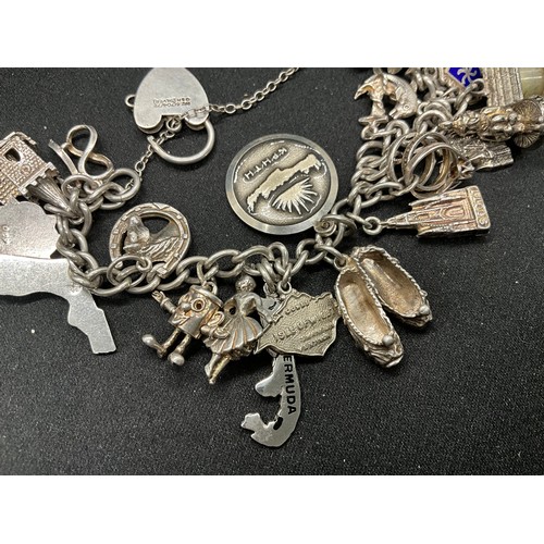 41 - 2 SILVER CHARM BRACELETS (TESTED) WITH TOTAL OF 32 SILVER & WHITE METAL CHARMS  TW94.1G
1 LOCKET IS ... 