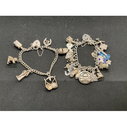 41 - 2 SILVER CHARM BRACELETS (TESTED) WITH TOTAL OF 32 SILVER & WHITE METAL CHARMS  TW94.1G
1 LOCKET IS ... 